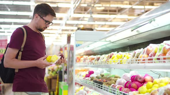 Male Shopper is Buying Fruits in Supermarket