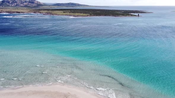 incredibly clear and turquoise water on the white beach of La Pelosa in Stintino (Sardinia), with sm