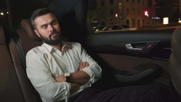 Business Man Napping At Backseat