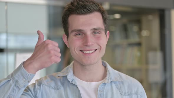 Portrait of Successful Young Designer Showing Thumbs Up