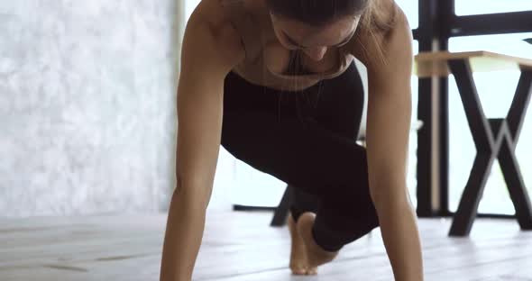 Young Athletic Woman Doing Exercises on Floor