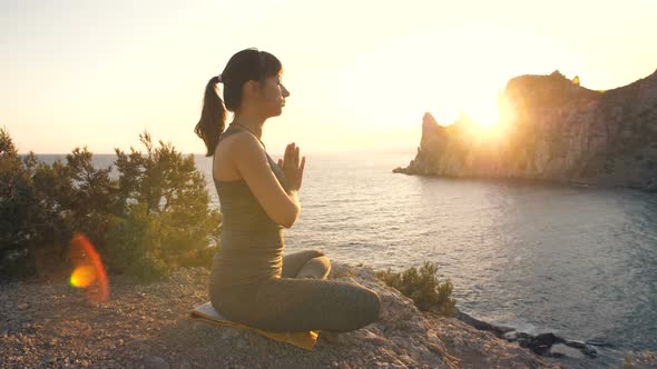 Young Woman Do Yoga at the Cliff