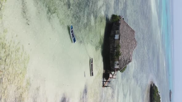 Vertical Video House on Stilts in the Ocean on the Coast of Zanzibar Tanzania Aerial View