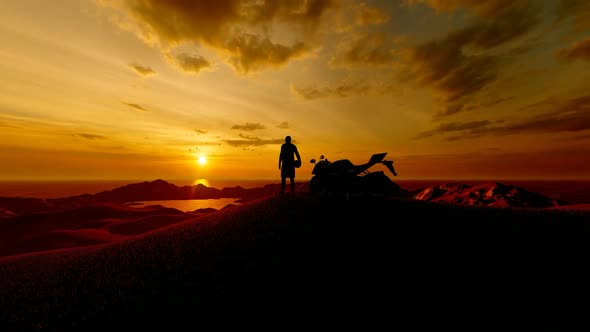 Young Man Watching Sunset on Mountain Top with Motorcycle