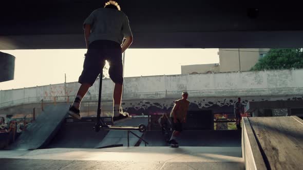 Friends Training Dangerous Trick on Scooter Skateboard Roller Skates Bmx Bike