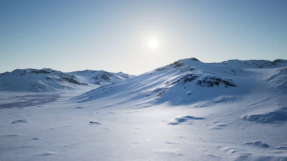 Aerial Landscape of Snowy Mountains and Icy Shores in Antarctica