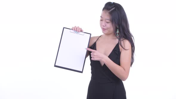 Happy Beautiful Asian Woman Showing Clipboard and Giving Thumbs Up