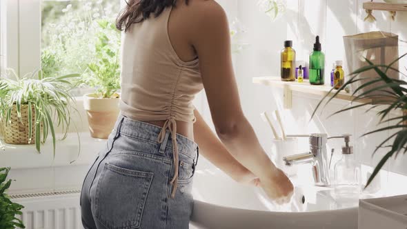 Unrecognisble Woman with Dark Skin Washing Hands