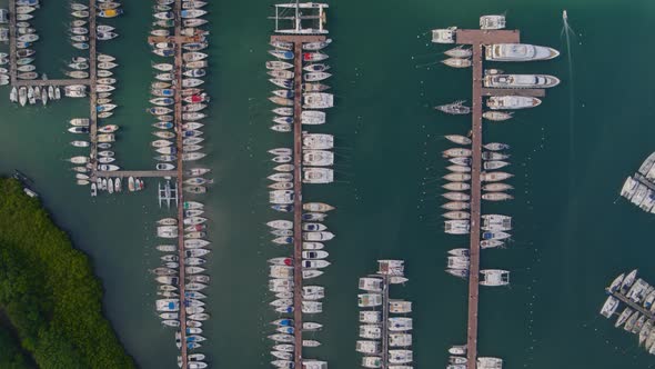 Aerial of boats moored on jetty at marina harbor, overhead view, Le Marin