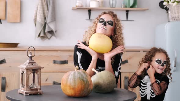 Mother and Daughter with Curly Hair Wearing Halloween Costumes