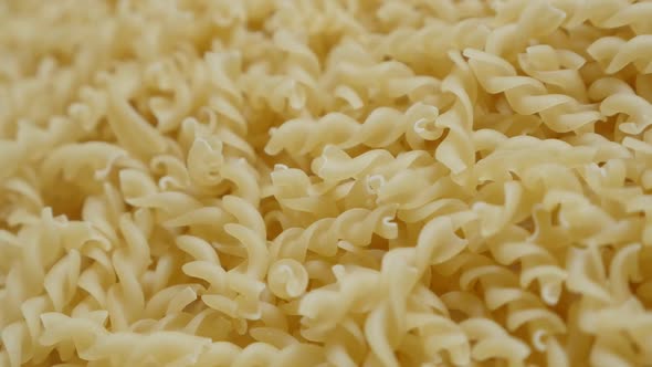 Slow motion fall on table corkscrew shaped pasta  close-up 1920X1080 HD footage - Falling on top pie