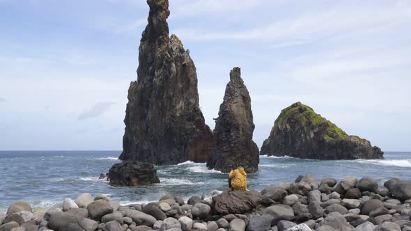 Woman looking at Ribeira da Janela islet in Madeira