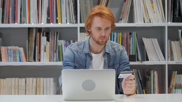Online Shopping by Redhead Man in Office