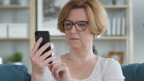 Portrait of Old Senior Woman Busy Using Smartphone