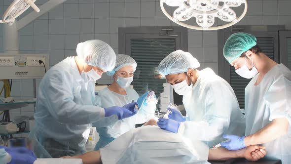The Anesthesiologist Team Takes Care of Patient Lying on Operation Table