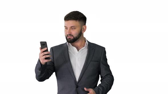 Handsome Businessman Walking and Recording Story for a Social Network on White Background