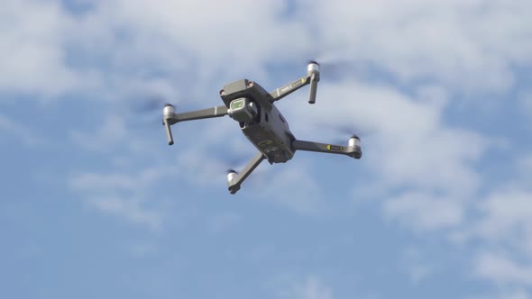 Aerial view of a professional drone with propellers flying with camera