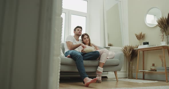 Movie Time for a Young Couple in Pajamas Spending