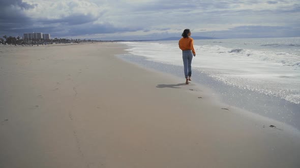 Running happy girl by the ocean