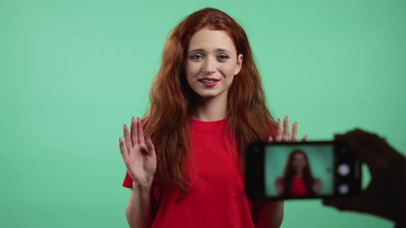 Smiling Fashion Blogger Woman Making Online New Video Blog Vlog with Her Smartphone on Green