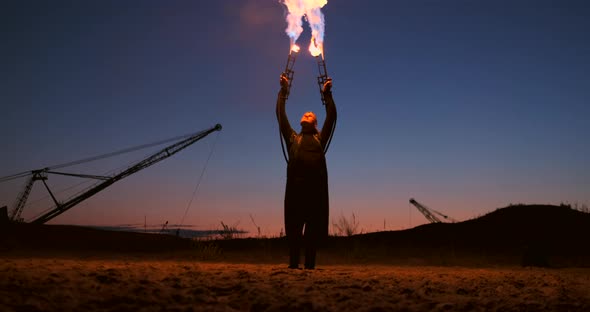 A Man with a Flamethrower at Sunset in Slow Motion