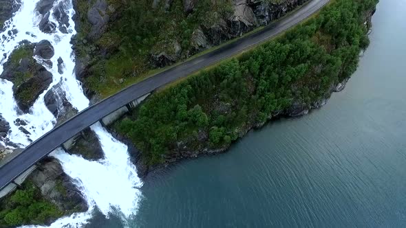 A Large Waterfall Flows Under the Highway