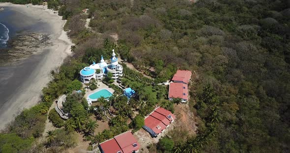 Aerial drone view of the beach, rocks and tide pools in Guiones, Nosara, Costa Rica