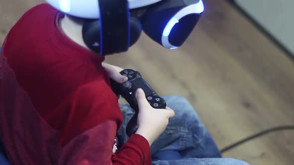Boy Is Playing In The Helmet Of Virtual Reality