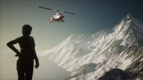 Woman and Helicopter in Winter Mountains