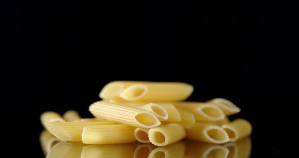 A Bunch of Dry Penne Pasta on the Table Slowly Rotates. 