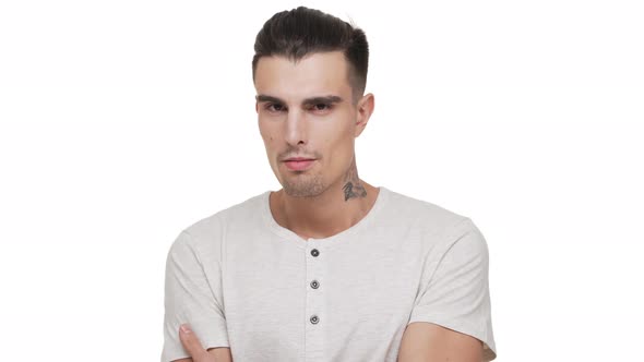 Portrait of Caucasian Emotional Guy with Short Dark Hair and Tattoo on Neck Posing Looking on Camera