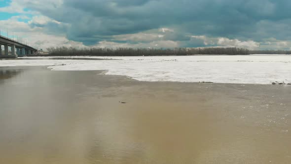 Landscape of Broad Partly Melted From Ice Running River