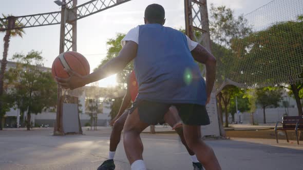 Cinematic footage of a street basketball game outdoor.