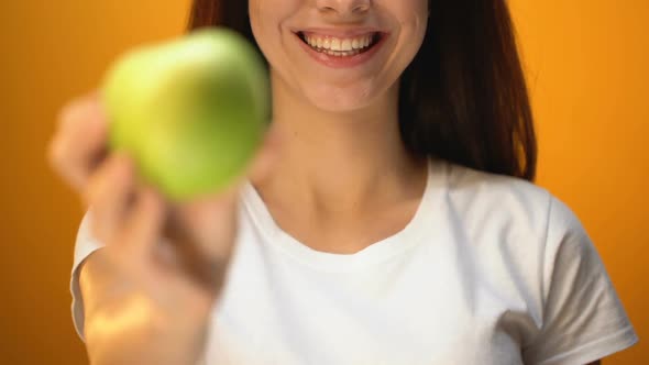 Girl Showing Apple to Camera Closeup, Health and Dental Care, Vitamins at Diet