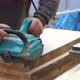 Working Man Is Polishing a Piece of Wood with a Machine for Grinding in the Hands - VideoHive Item for Sale