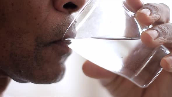 man drinking water from a glass on white background stock video stock footage