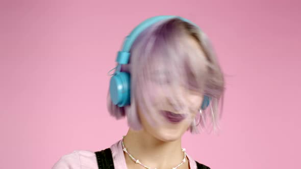 Close-up Portrait of Pretty Girl with Dyed Violet Hair Listening To Music, Smiling, Dancing in