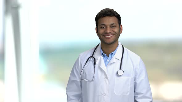 Handsome Medical Doctor Looking at Camera on Blurred Background.