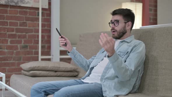 Portrait of Attractive Male Designer Reacting To Failure on Television