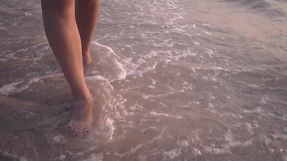 Barefoot Lady Legs Walk Along Waves on Shore Slow Motion