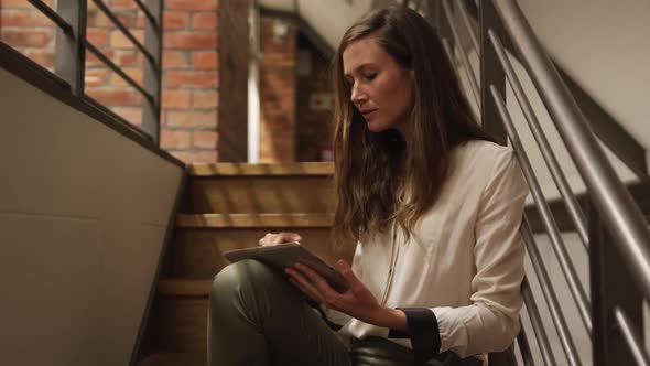 Creative businesswoman using digital table in modern office