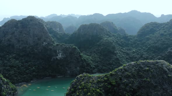 Aerial: flying over Ha Long Bay rock pinnacles, famous tourism destination in Vietnam