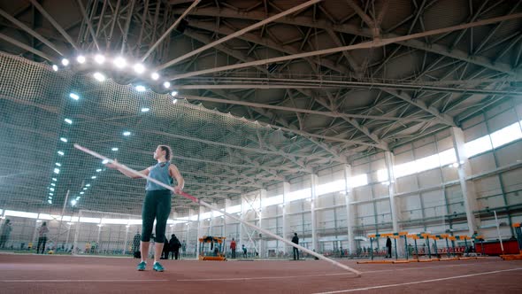 Pole Vaulting - the Sportswoman Is Taking a Long Pole and Running