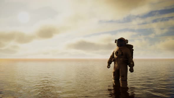 Spaceman in the Sea Under Clouds at Sunset alt