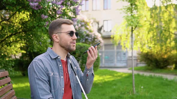 Blind Man with Disability Using Digital Assistant and Ease of Access Functions on Smartphone