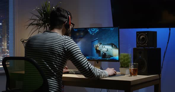 Young Man Playing Video Game Inside a Room