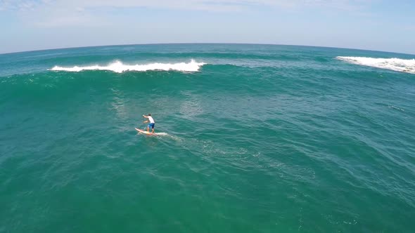 Aerial view of a wipeout while sup stand-up paddleboard surfing in Hawaii