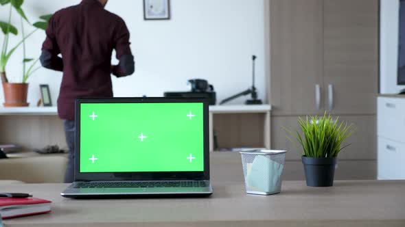 Modern Laptop with an Isolated Green Screen Chroma Mock Up on the Table