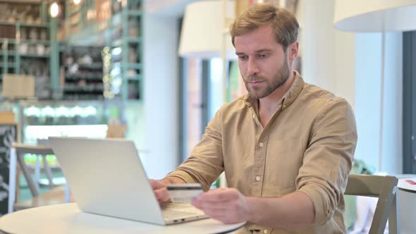 Online Payment Success on Laptop By Young Man 