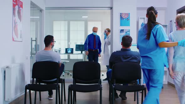 Nurse and Senior Patient Going in Consultation Room